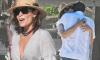 Luann de Lesseps flashes her toned tummy in a knotted top before hugging a dark-haired mystery man on the beach in Mexico