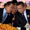 Hun Sen (left) speaks to his son Hun Manet during a ceremony marking the 74th founding anniversary of the Cambodian People’s Party in Phnom Penh in June
