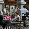 Tourists drink beverages as a waitress picks up chairs during closing time at the restaurant in Guayaquil, Ecuador, where local mafias shut down the party in the traditional red-light districts with drug-related violence.