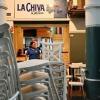 A waitress works during closing time at a restaurant in Guayaquil, Ecuador, where local mafias have violently shut down the party in the traditional red-light districts