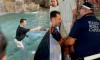 Moment idiot tourist is led away by Italian police after jumping into Rome's ancient Trevi Fountain