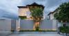curved textile facades wrap reborn house in bangkok village emitting soft glow