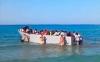 Migrant boat pushed back to sea by sunbathers on Greek island
