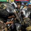 Medical students are pushed with shields and clubs by Malagasy security forces during a demonstration in Antananarivo, on October 7, 2025, where protests have rumbled for two weeks