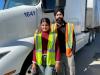 Young truck driver couple embraces flatbed trucking, balanced lifestyle