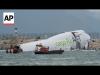 Cargo aircraft skids off a Hong Kong runway into sea, killing 2 airport workers