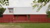 Gaiss tops red home in Latvia with corrugated metal roof