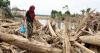 asia Indonesians climb over logs in walk to aid centre as flood deaths exceed 900