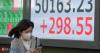 Japan's Nikkei ends higher as tech shares track Nasdaq gains