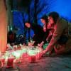 Women light candles at a makeshift memorial outside the Zagreb school where the stabbing happened
