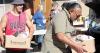 Volunteers make food giveaway fun; Church group feeds over 100 families monthly
