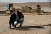 World AFP Iraqis cover soil with clay to curb sandstorms