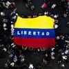 Venezuelans living in Argentina display a Venezuelan flag that reads "Freedom" as they celebrate the toppling of strongman Nicolas Maduro