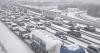 Travel chaos as hundreds of flights to Europe cancelled and snow causes 1000km traffic jam
