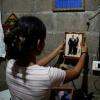 Jade, 16, holds a picture of her father Jose Roger Urquilla in her home in El Rosario, El Salvador, on December 3, 2025. El Salvador President Nayib Bukele's gang crackdown reduced violence to a minimum but has separated children from parents.