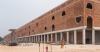 concrete canopies and porous brick walls form central market redevelopment in congo