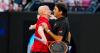 Andre Agassi walks off court after comment in Roger Federer match at Australian Open