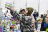 Volunteers pack bags of food, toiletries for families afraid to go out amidst ICE surge