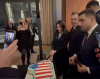 Republican Congressmen cut Greenland cake covered in U.S. flag at D.C. gala