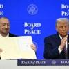 Azerbaijan's President Ilham Aliyev holds a signed founding charter of the "Board of Peace" as US President Donald Trump applauds during the World Economic Forum in Davos, Switzerland