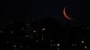 The waxing crescent moon is seen above buildings in Buenos Aires on January 21, 2026.