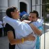 Venezuelan human rights activist Javier Tarazona (right) reunites with his brother Jose Rafael Tarazona (left) and lawyer Omar de Dios Garcia after his release from prison