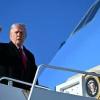 US President Donald Trump gestures as he boards Air Force One at Fort Bragg, North Carolina