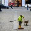 Thankless: a foreign worker sweeps a street in central Zagreb