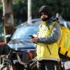 A foreign delivery rider checks on his orders in central Zagreb