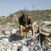 A member of the Salhab family sits on the on the rubble of an apartment building demolished by Israeli bulldozers near the Israeli settlement of Hagai in the occupied West Bank