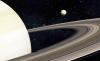 Tiny moon of Saturn exerts unexpected forces on the entire solar system
