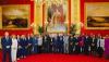 King poses with Grenada delegates under portrait of George IV, the monarch who profited personally in the 19th century from...