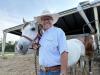 ‘Cowboy Doctor’ checking eyes, mucking stalls