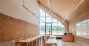 concrete and beech shape flexible learning spaces within school and social hub in slovenia