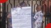 Unemployed lady takes to Nairobi CBD with placard, seeks job opportunity with baby on her back