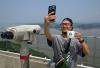 Stark contrast: Coffee with a view: tourists flock to Starbucks overlooking North Korea