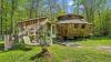 ‘Rugged’ Yurt-Shaped Cabin Perched on 6 Lush Acres in New Hampshire Is Listed for Just $300K