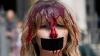 Activists covered in red paint protest bullfighting in Pamplona