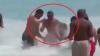 Dramatic moment hero onlookers pummel vile abuser who launched horrific attack on wife on packed beach in broad daylight