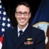 Greer, local Navy officer, specializing in intelligence, artificial intelligence