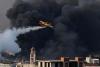 Greek firefighters battle fire at business site, at least two injured