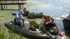Volunteers gather to remove invasive plant that’s choking waterway in Greece