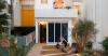 exposed brick and blue metal transform a 1930s brazilian house into a cultural art hub