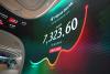 World shares are mixed and oil prices climb as Iran threatens to block Middle East energy exports