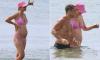 Pregnant Vogue Williams shows off her bump in a pink bikini as she hits the beach with shirtless Spencer Matthews in Spain