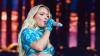 Zara Larsson showcases incredible abs in blue bra and micro mini at music festival