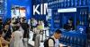 Amid a wall of blue tote bags, China’s vaulting AI ambitions come into view