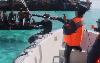 Bizarre moment Chinese & Filipino sailors in dinghies whack each other with oars & batons as one injured