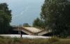 Greek drivers defy warnings to inch across buckled bridge
