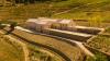 Quinta de Adorigo’s sinuous timber profile mirrors Portugal’s oldest vineyards